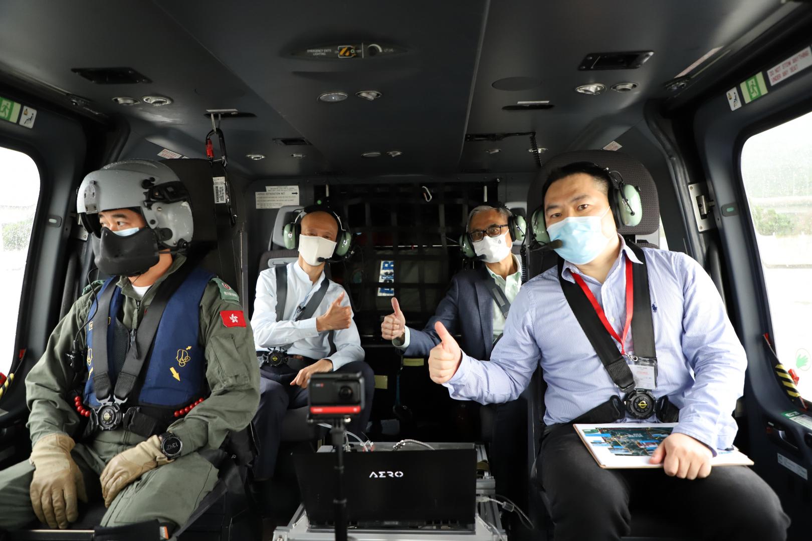環境局局長黃錦星先生（後排左）、科大校長史維教授（後排右）及科大環境及可持續發展部副教授寧治（前排右）一同乘搭直升機，了解臭氧研究進度。