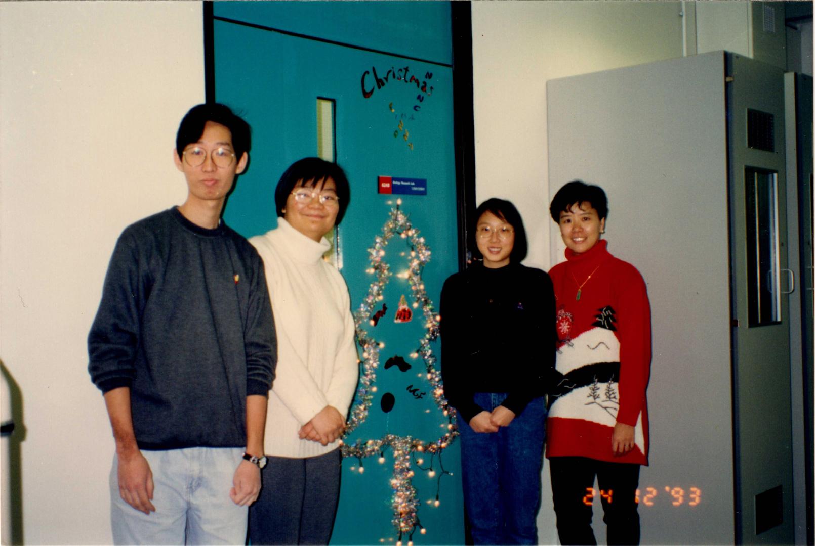Prof. Ip (First right) celebrates first Christmas at HKUST in 1993 in front of her laboratory with her research team members, some of whom are still her aide to date.