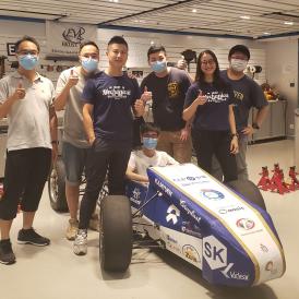 Prof. Liem and students with an Electronic Vehicle